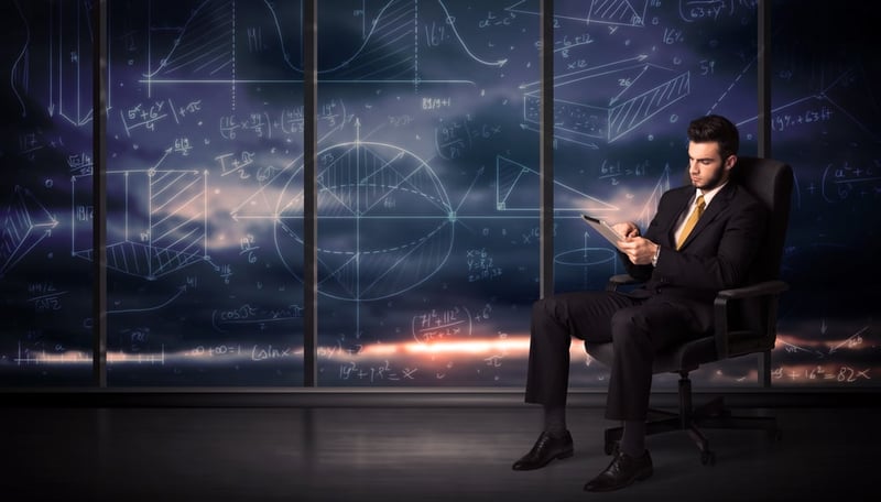 Businessman holding tablet in office room with graph charts on window concept